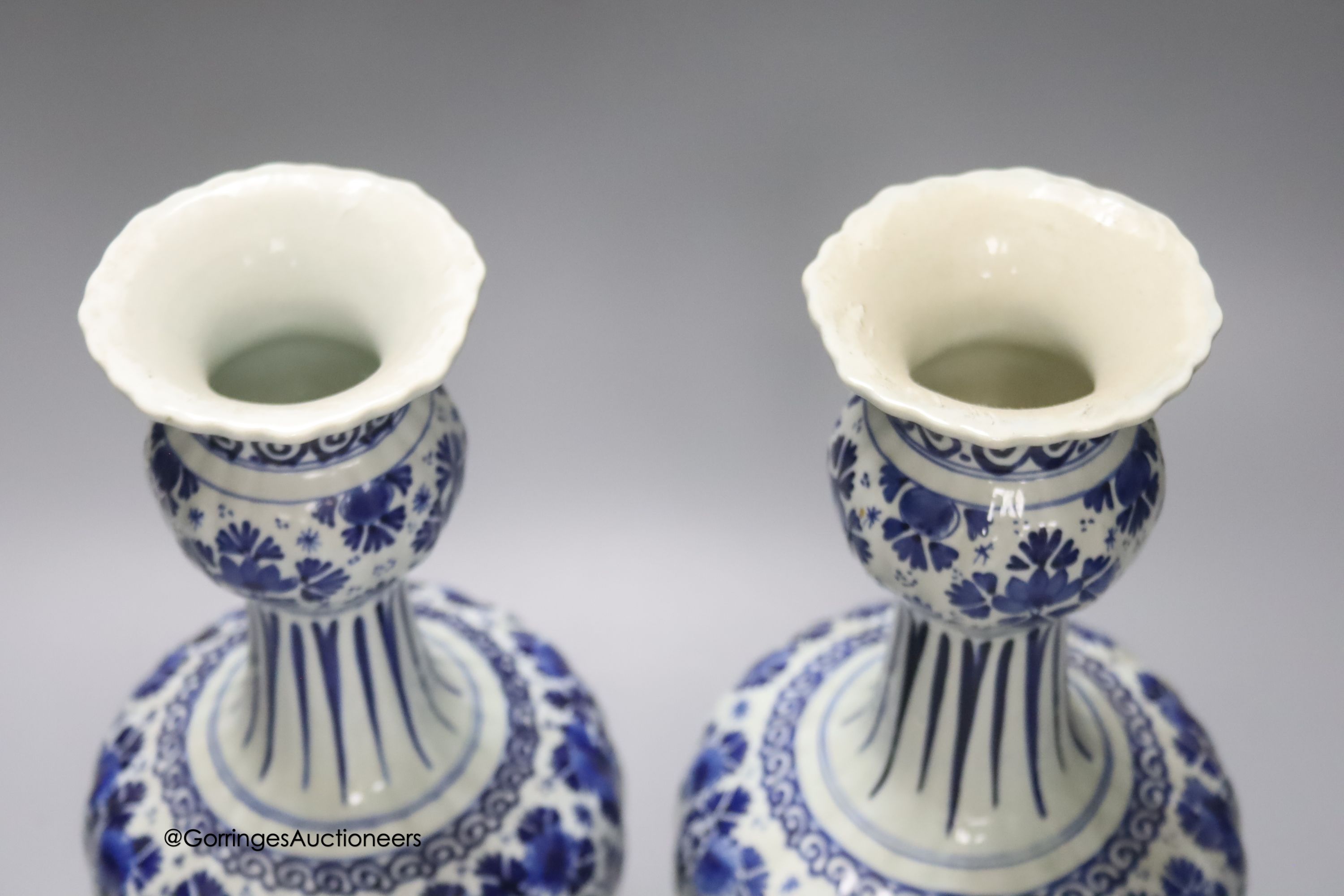 A pair of Dutch Delft blue and white vases, 29cm, a similar ovoid jar and cover and a bulbous jug